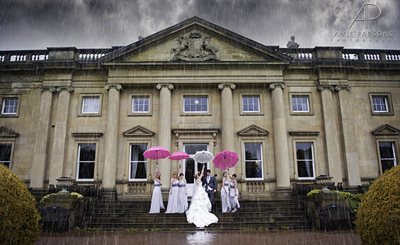 Sheffield wedding photography umbrellas rain bride and groom with bridal party